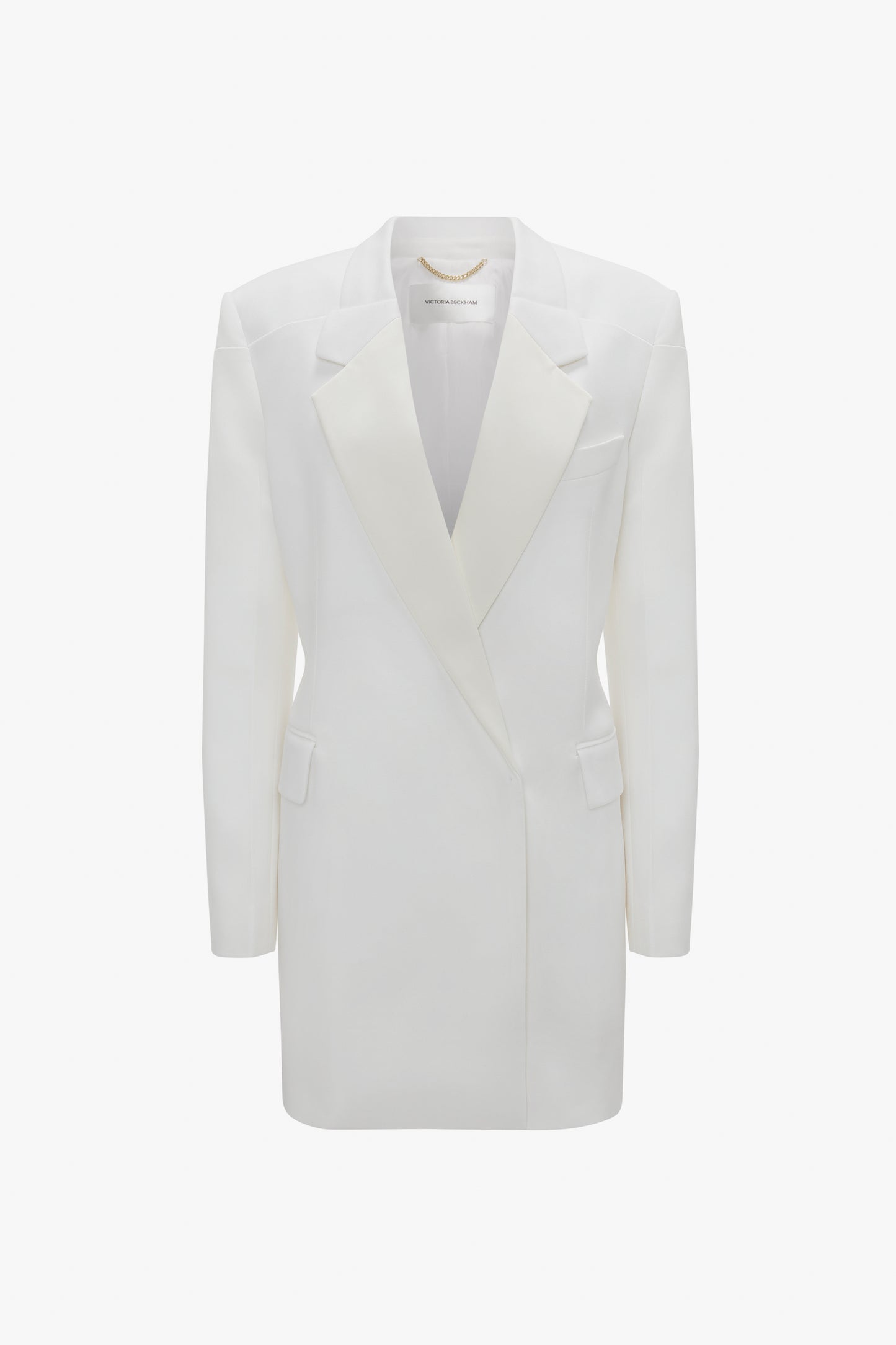 Double-breasted white tuxedo-style long jacket with peaked lapels and two side flap pockets, isolated on a white background from Victoria Beckham's Exclusive Fold Shoulder Detail Dress In Ivory collection.