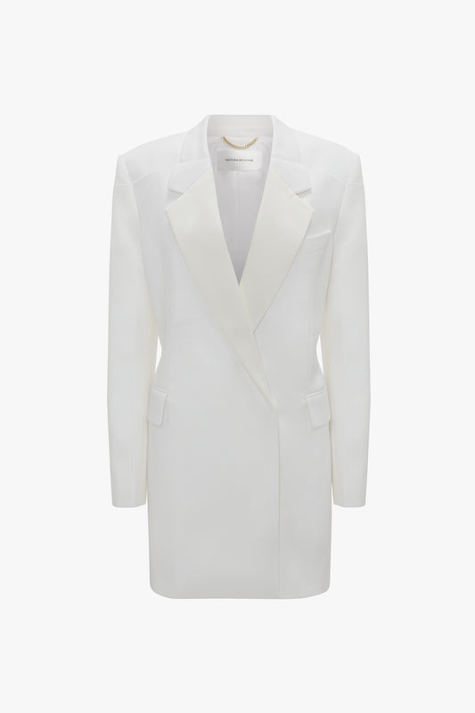 Double-breasted white tuxedo-style long jacket with peaked lapels and two side flap pockets, isolated on a white background from Victoria Beckham's Exclusive Fold Shoulder Detail Dress In Ivory collection.
