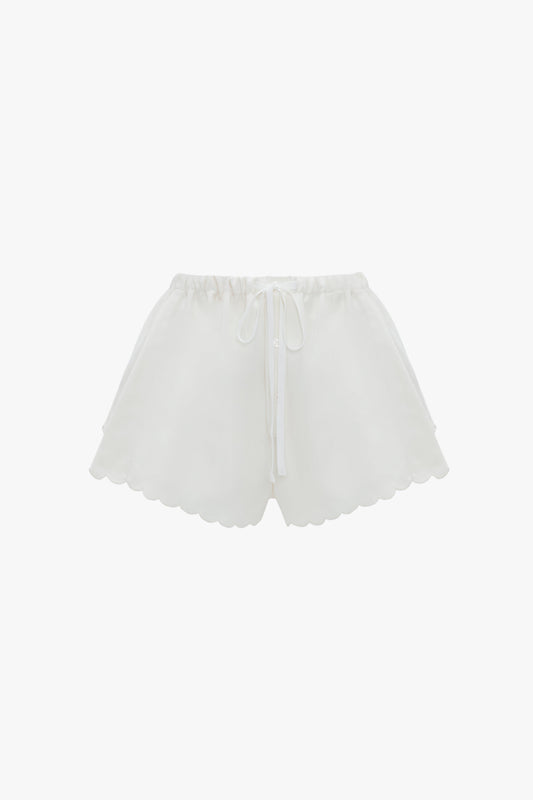 Drawstring Embroidered Mini Short In Antique White by Victoria Beckham with an elastic waistband and drawstring tie, featuring a vintage appeal, displayed on a plain white background.