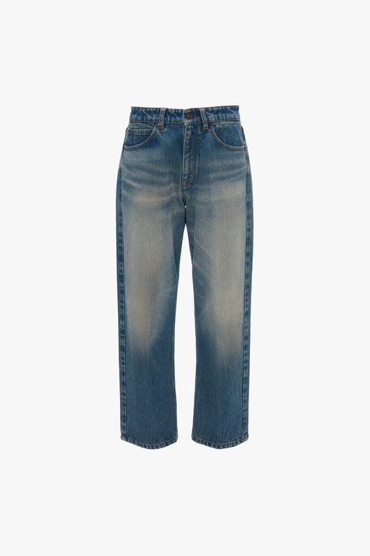 A pair of Victoria Beckham Relaxed Straight Leg Jeans In Antique Indigo Wash with cropped legs, displayed against a white background.