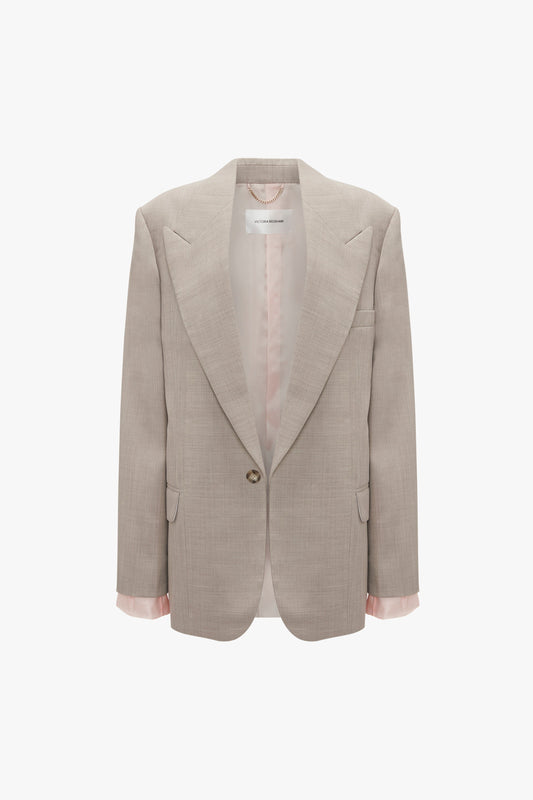 A beige Darted Sleeve Tailored Jacket In Sesame with a single button and wide lapels. The interior lining is visible, and the sleeves feature pink cuffs. This pure wool blazer by Victoria Beckham, which debuted on the SS24 runway, is showcased against a white background.