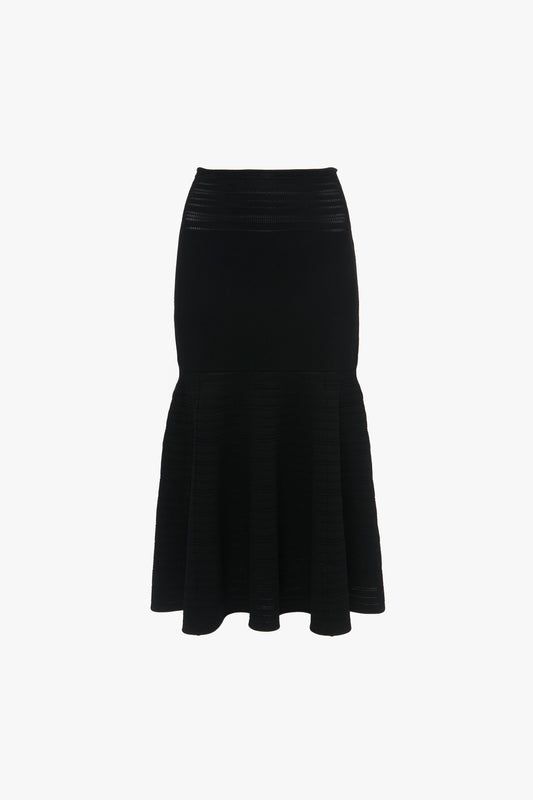 Victoria Beckham's Fit And Flare Midi Skirt In Black is a black, mid-weight stretch knit high-waisted skirt with a fitted upper portion, contrasting stitching, and a flared hem.