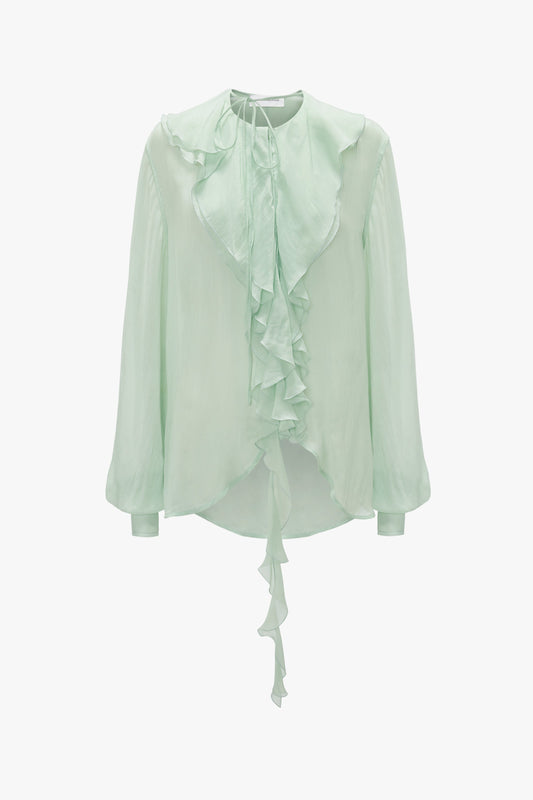 A Victoria Beckham Romantic Blouse In Jade, with long blouson sleeves, a ruffled front, and a tie at the neck, displayed against a plain white background.