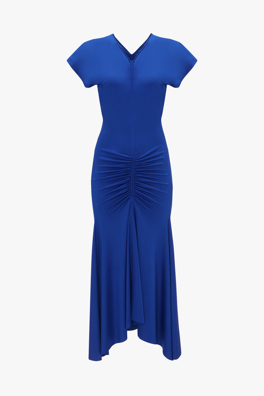A Victoria Beckham royal blue dress with a v-neckline, cap sleeves, and ruched detailing at the waist, featuring a flared hemline.