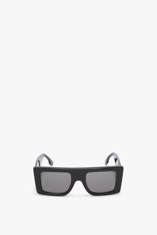 A pair of Victoria Beckham Oversized Frame Sunglasses In Black with dark lenses and a bold oversized frame on a white background.
