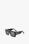 Rectangular black sunglasses with a bold oversized frame and dark lenses, featuring a sleek and modern metallic accent on the temples, like the Oversized Frame Sunglasses In Black by Victoria Beckham.