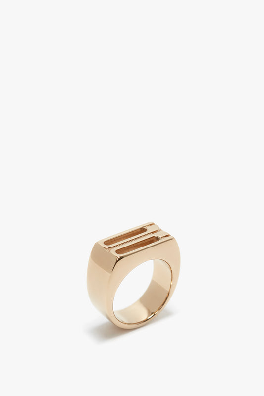 Victoria Beckham Exclusive Frame Signet Ring In Gold, with a rectangular face, isolated on a white background.