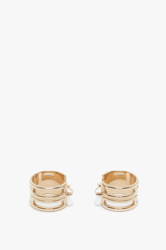 A pair of Exclusive Frame Hoop Earrings In Gold by Victoria Beckham with a textured design and latch back closures are shown against a plain white background, reminiscent of luxury styles from Italy.
