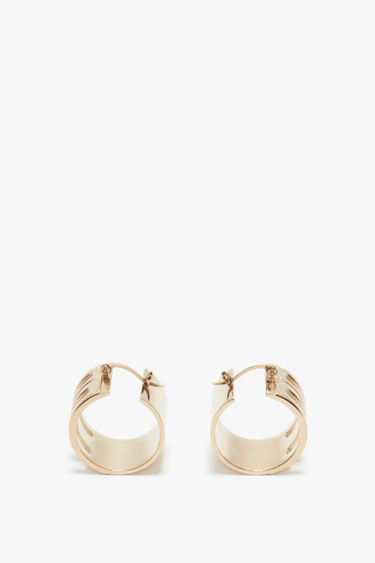 A pair of Exclusive Frame Hoop Earrings In Gold by Victoria Beckham with hinge closures, shown against a white background.