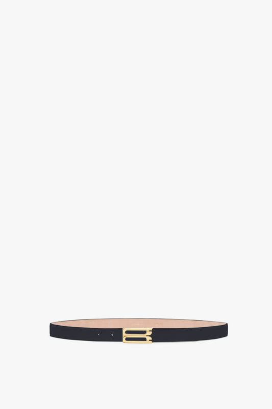 A narrow, Victoria Beckham Exclusive Frame Belt In Midnight Navy Leather with a small, gold buckle, centered against a neutral background.