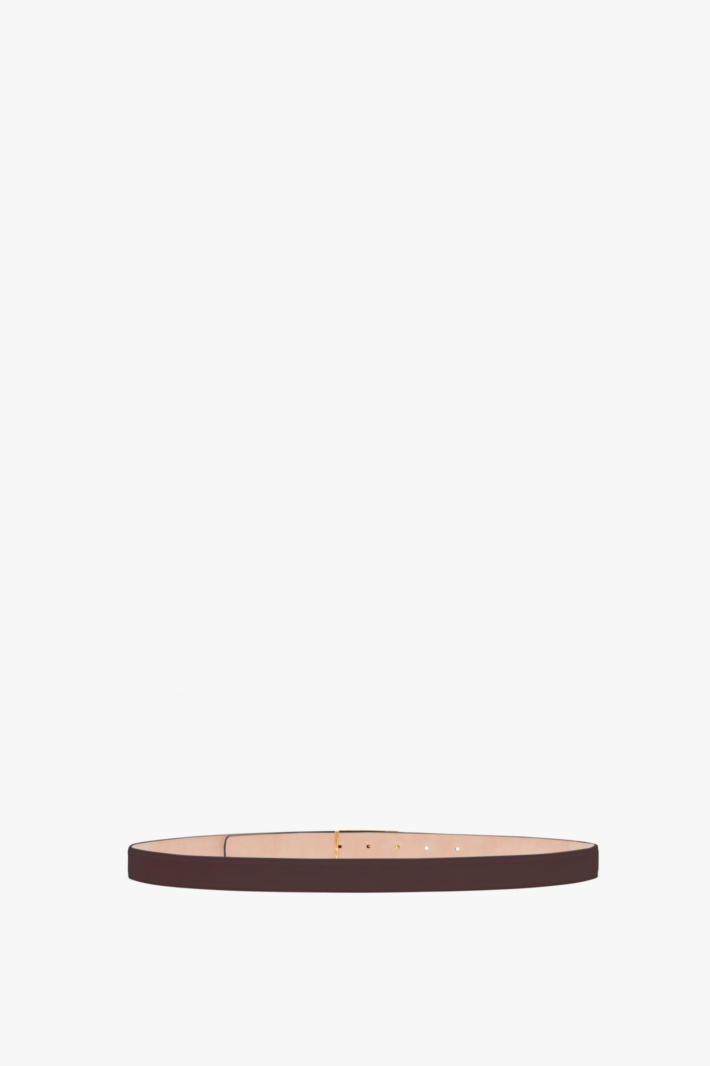 Thin brown calf leather belt with a classic design, featuring a simple buckle and multiple adjustment holes. The Frame Belt In Burgundy Leather by Victoria Beckham is accentuated by gold hardware for an elegant touch.