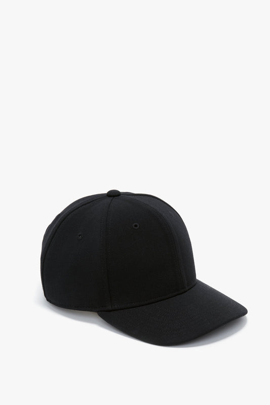 A plain black wool crepe Exclusive Logo Cap in Black by Victoria Beckham with a flat brim, displayed against a white background.