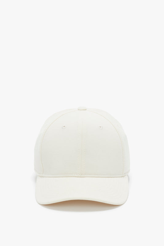 Front view of a Victoria Beckham Antique White Logo Cap isolated on a white background.