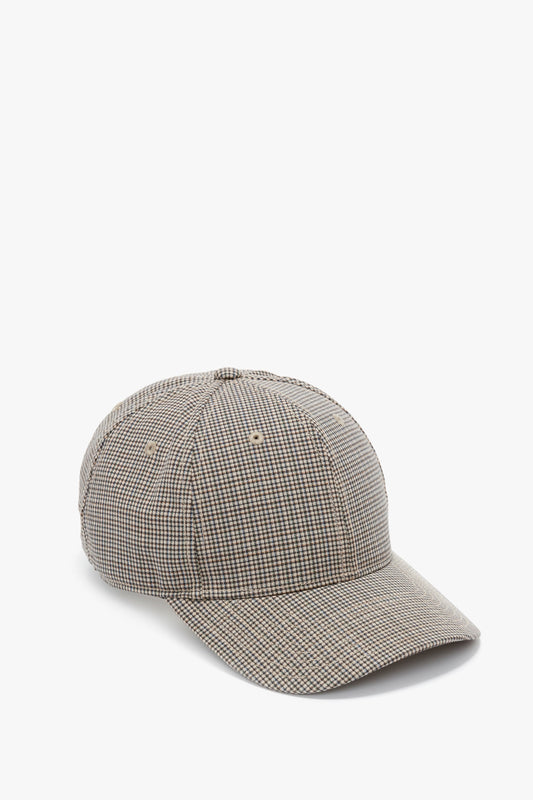 A wool Logo Cap In Dogtooth Check baseball cap by Victoria Beckham isolated on a white background.