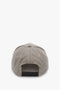 A beige and brown checkered baseball cap made from wool dogtooth check, viewed from the back, showcasing its minimalist design with an adjustable snapback closure. This is the Logo Cap In Dogtooth Check by Victoria Beckham.