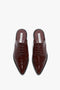 Top view of a pair of Victoria Beckham Flat Lace Up Mules In Bordeaux Leather with laces and decorative Oxford brogue perforations.