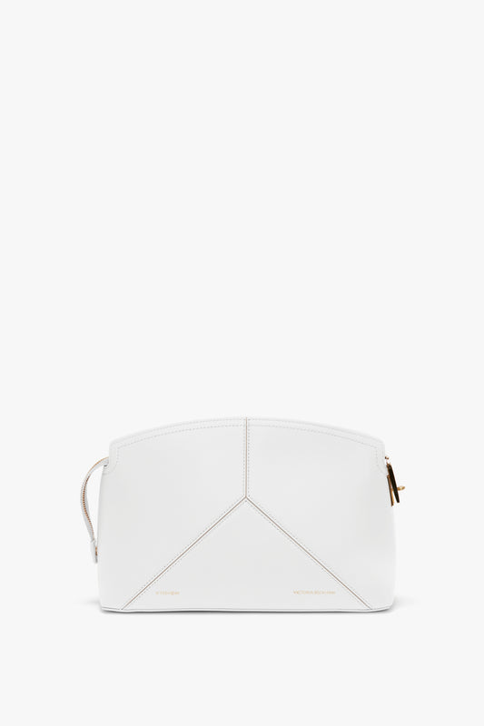 A white geometric handbag with gold hardware and minimal stitching, featuring a top-zip closure and a branded padlock for added security.
Product Name: Exclusive Victoria Clutch Bag In White Leather Brand Name: Victoria Beckham

Replaced Sentence:
The Exclusive Victoria Clutch Bag In White Leather by Victoria Beckham features a white geometric design with gold hardware and minimal stitching, complemented by a top-zip closure and a branded padlock for added security.