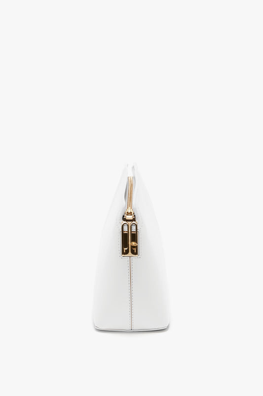 Side profile of the Victoria Beckham Exclusive Victoria Clutch Bag In White Leather with a gold zipper and hardware, featuring a chic branded padlock.