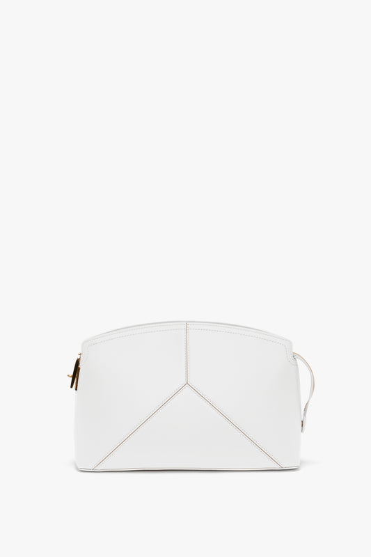A white leather pouch with a zip closure and a minimalist, structured design, featuring subtle stitching patterns on the front has been replaced with the Exclusive Victoria Clutch Bag In White Leather by Victoria Beckham.