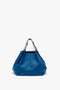 A W11 Medium Tote Bag In Vibrant Blue by Victoria Beckham, featuring two dark handles and a geometric design on the front, displayed on a white background.