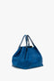 A Victoria Beckham W11 Medium Tote Bag In Vibrant Blue grained leather, with double straps and a relaxed, slouchy shape, placed against a plain white background.