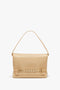 Chain Pouch Bag With Strap In Sesame Leather by Victoria Beckham with a single top handle, featuring a woven strap detail across the front and a gold chain detail for added elegance.