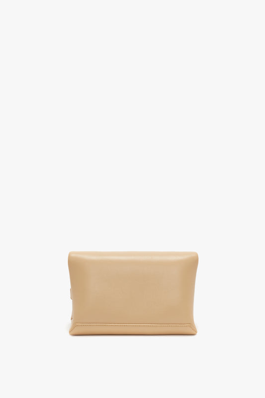 A Victoria Beckham Mini Pouch With Long Strap In Sesame Leather with a rectangular shape and rounded edges, displayed against a white background.