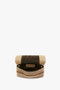 Tan and black Victoria Beckham mini pouch with long strap in sesame leather, isolated on a white background.