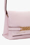 A Mini Chain Pouch Bag With Long Strap In Orchid Leather with a gold chain detail and the brand name "Victoria Beckham" embossed in gold on the lower front.