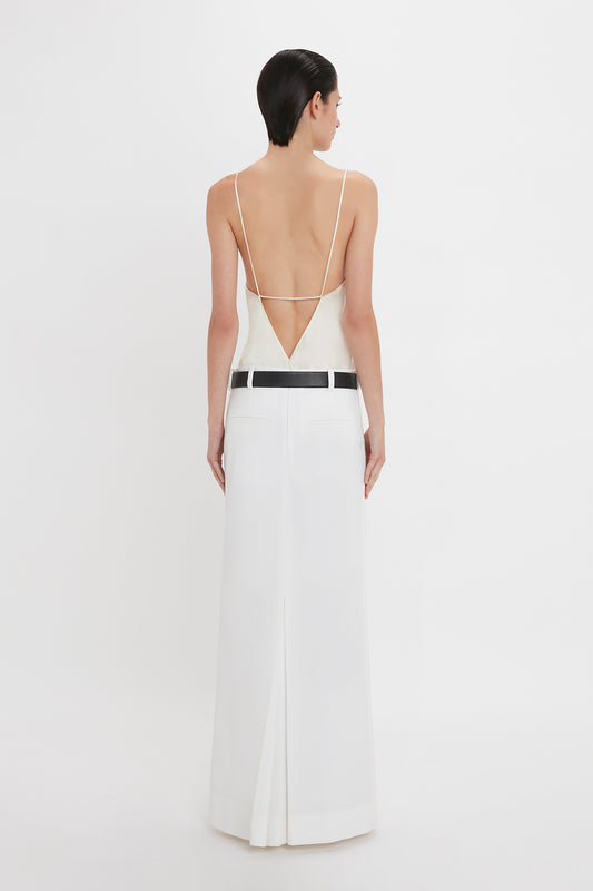 A person wearing an Exclusive Cami Top In Ivory by Victoria Beckham, standing facing away against a white background.