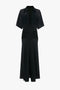 A Panelled Knit Dress In Black by Victoria Beckham, with short sleeves, a collared neckline, chest pockets, a fitted waist, and a flared skirt.