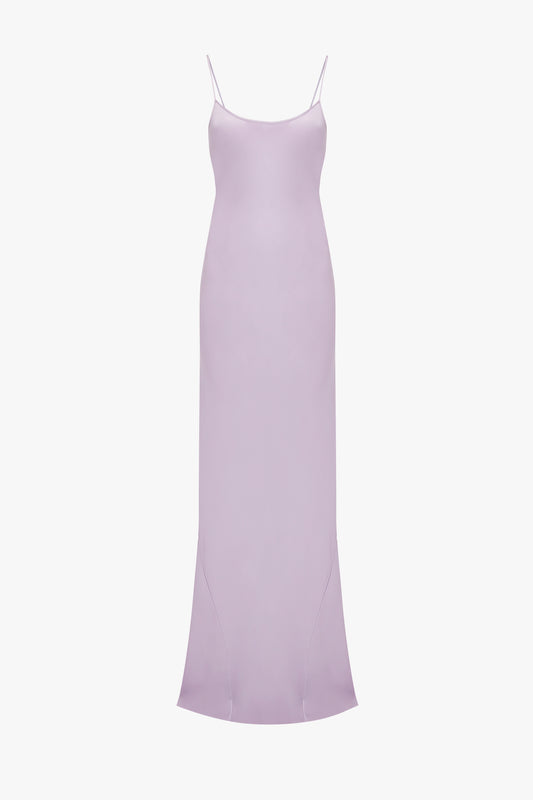 A plain light purple Low Back Cami Floor-Length Dress in Petunia from Victoria Beckham, with spaghetti straps and a slight flare at the hem, displayed against a white background.