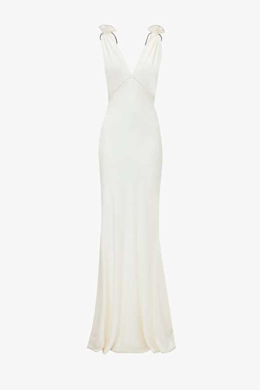 A Gathered Shoulder Floor-Length Cami Gown In Ivory from Victoria Beckham. The crepe back satin dress boasts a fitted bodice that flares slightly at the hem.