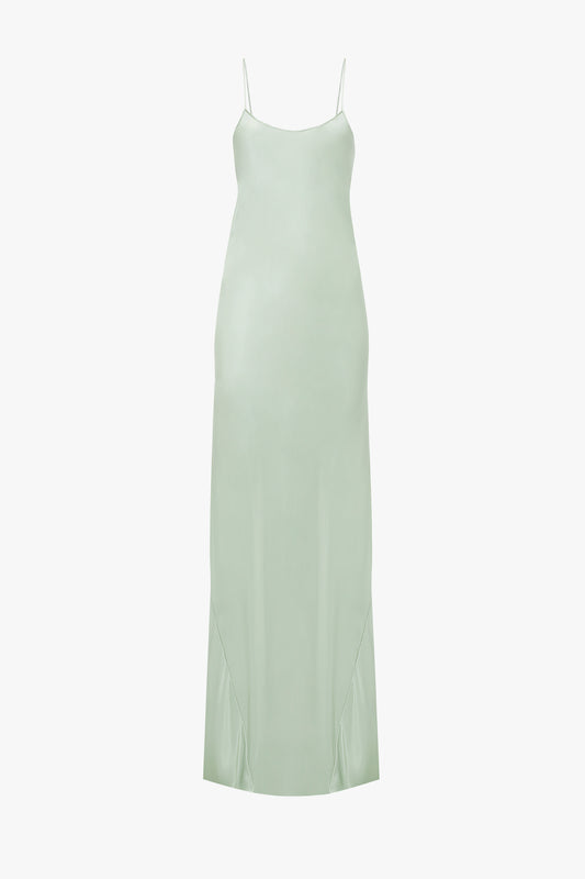 A pale green Exclusive Low Back Cami Floor-Length Dress In Jade with thin straps and a straight neckline, isolated on a white background by Victoria Beckham.