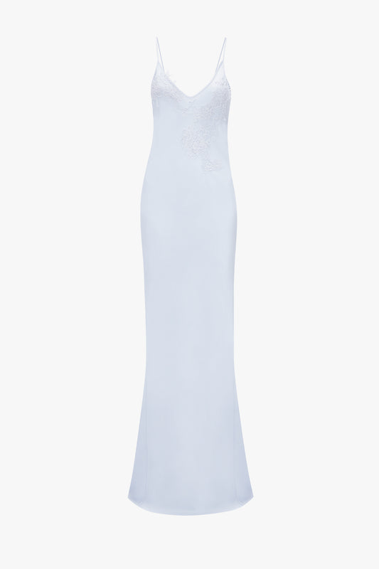 A 1990s light blue slip dress with delicate lace detailing on the bodice and thin spaghetti straps, isolated on a white background. 
A Victoria Beckham Exclusive Lace Detail Floor-Length Cami Dress In Ice.