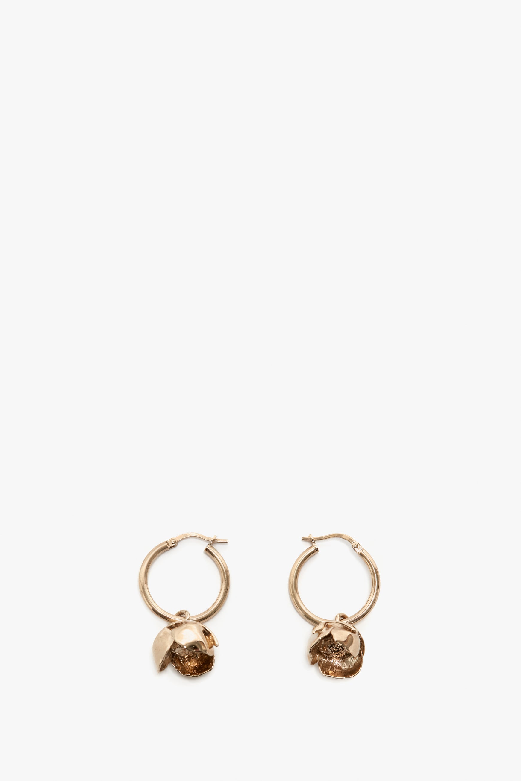 A pair of Exclusive Camellia Flower Hoop Earrings in Gold with attached rough-cut gemstones, displayed against a plain white background by Victoria Beckham.
