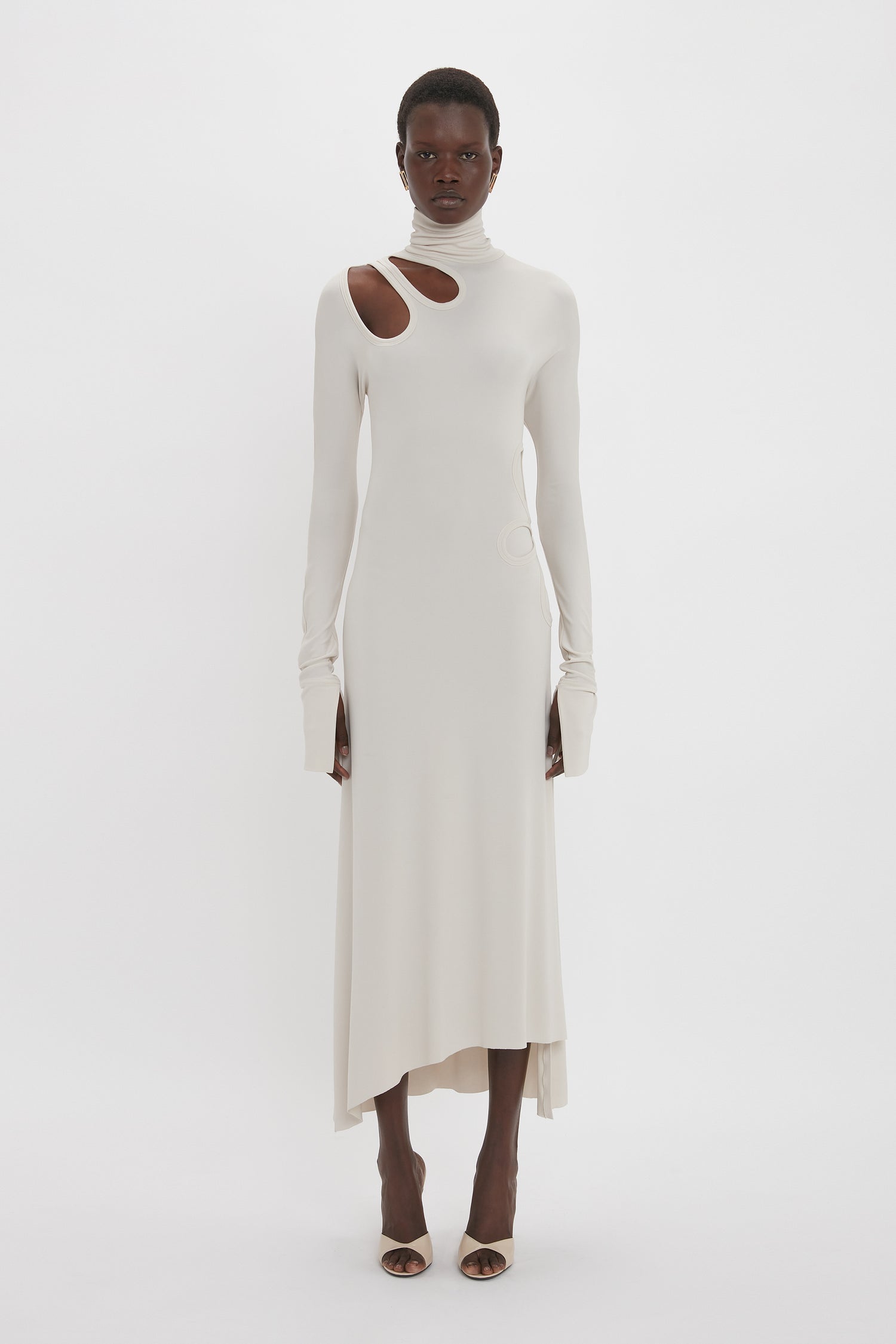 Person wearing a Long Sleeve Cut-Out Jersey Midi Dress In Bone by Victoria Beckham, posed against a plain white background.