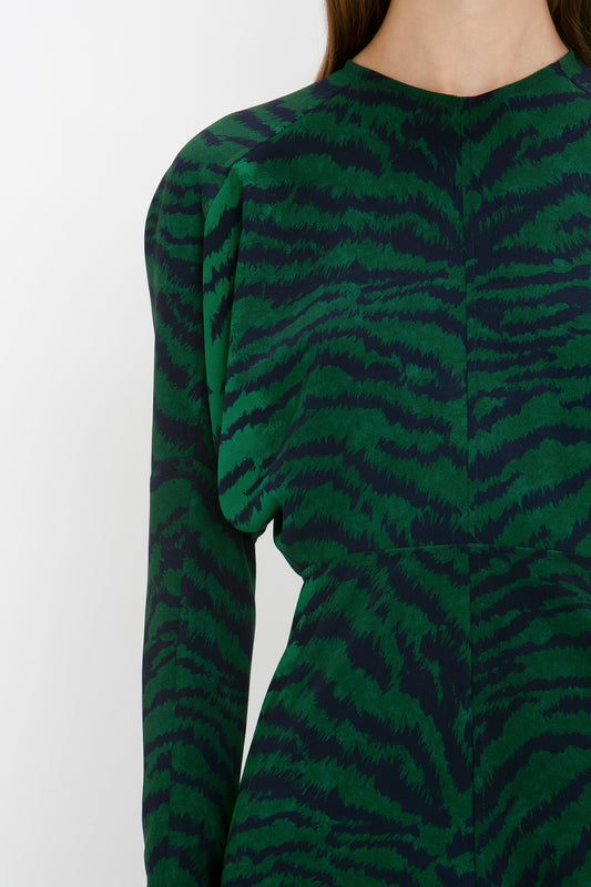 Close-up of a woman's back in a Victoria Beckham Dolman Midi Dress In Green-Navy Tiger Print with a keyhole cutout detail.