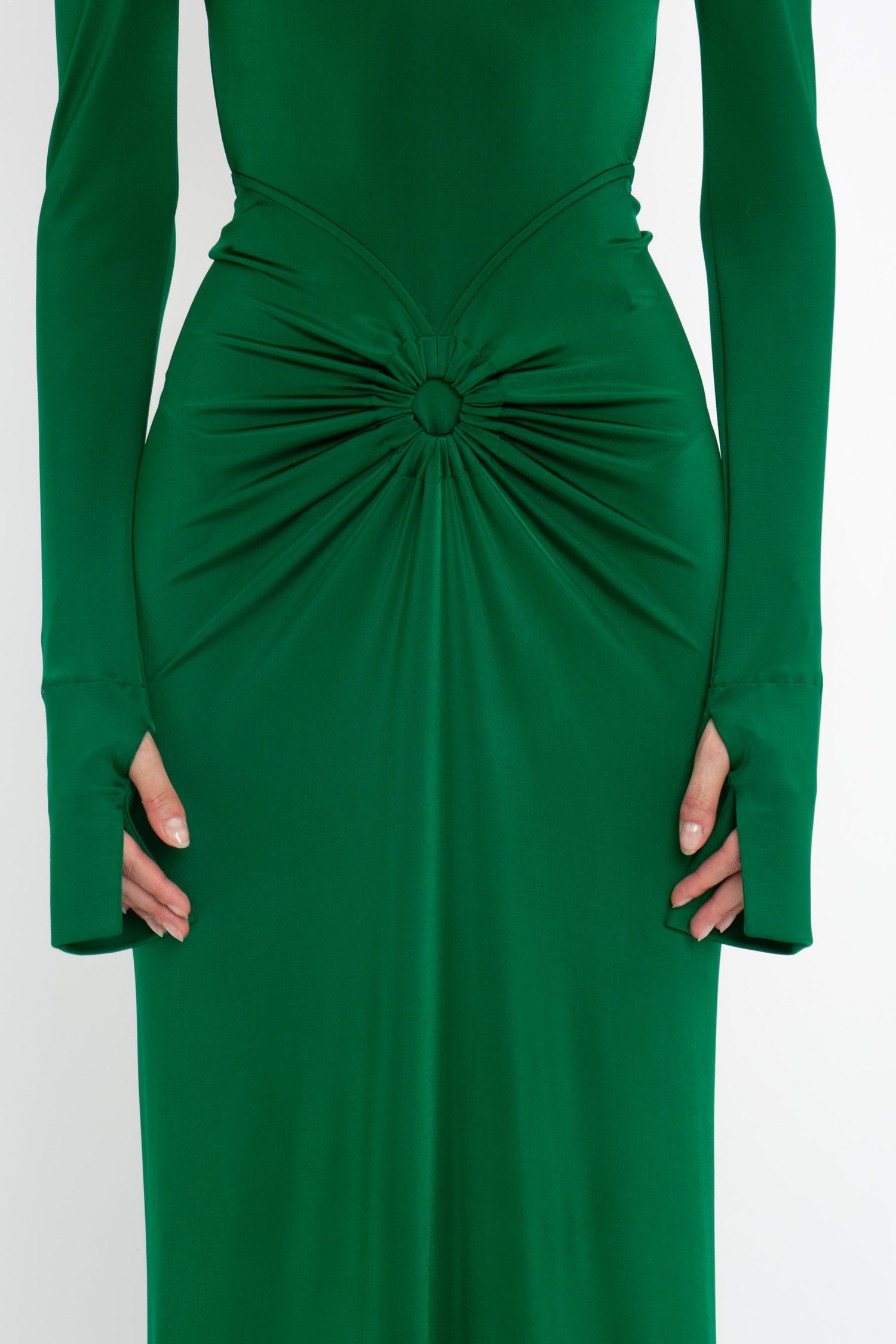 Person wearing a Circle Detail Open Back Gown in Emerald by Victoria Beckham. Hands are partially visible, resting against the sides of the dress.