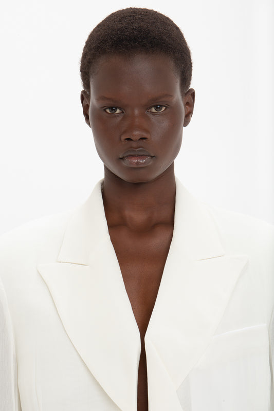 Person with short hair wearing the Fold Detail Tailored Jacket In White by Victoria Beckham, facing the camera against a plain white background.