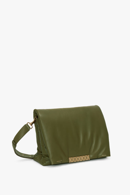 A Puffy Jumbo Chain Pouch In Khaki Leather crafted from sheepskin nappa leather with an adjustable shoulder strap and a gold clasp, displayed against a plain white background by Victoria Beckham.
