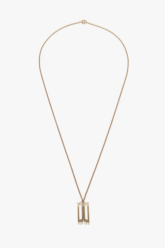 A gold-plated brass necklace with a thin chain featuring a rectangular Frame Charm Pendant designed with cut-out shapes, the Exclusive Frame Necklace In Gold by Victoria Beckham.