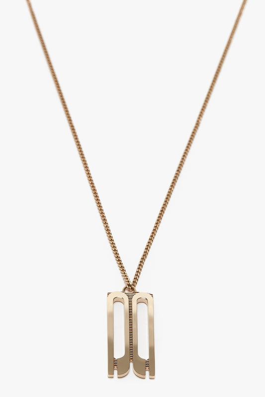 A gold-plated brass necklace with a thin chain features the Exclusive Frame Necklace In Gold shaped like the letters "D" and "J," reminiscent of the Victoria Beckham logo.
