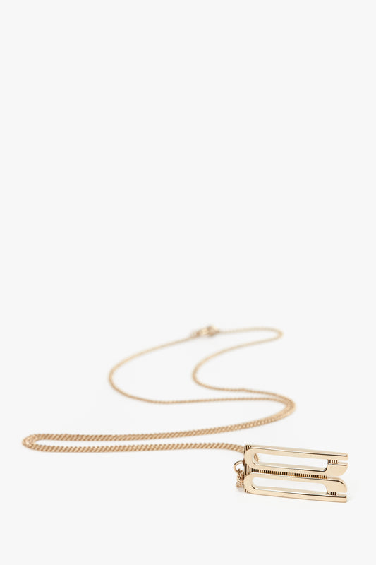 Exclusive Frame Necklace In Gold by Victoria Beckham featuring a unique rectangular frame charm pendant, crafted from gold-plated brass.