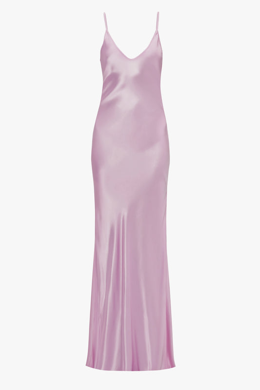 A light pink satin Victoria Beckham Low Back Cami Floor-Length Dress In Rosa with thin straps and a smooth, flowing silhouette, displayed against a white background.