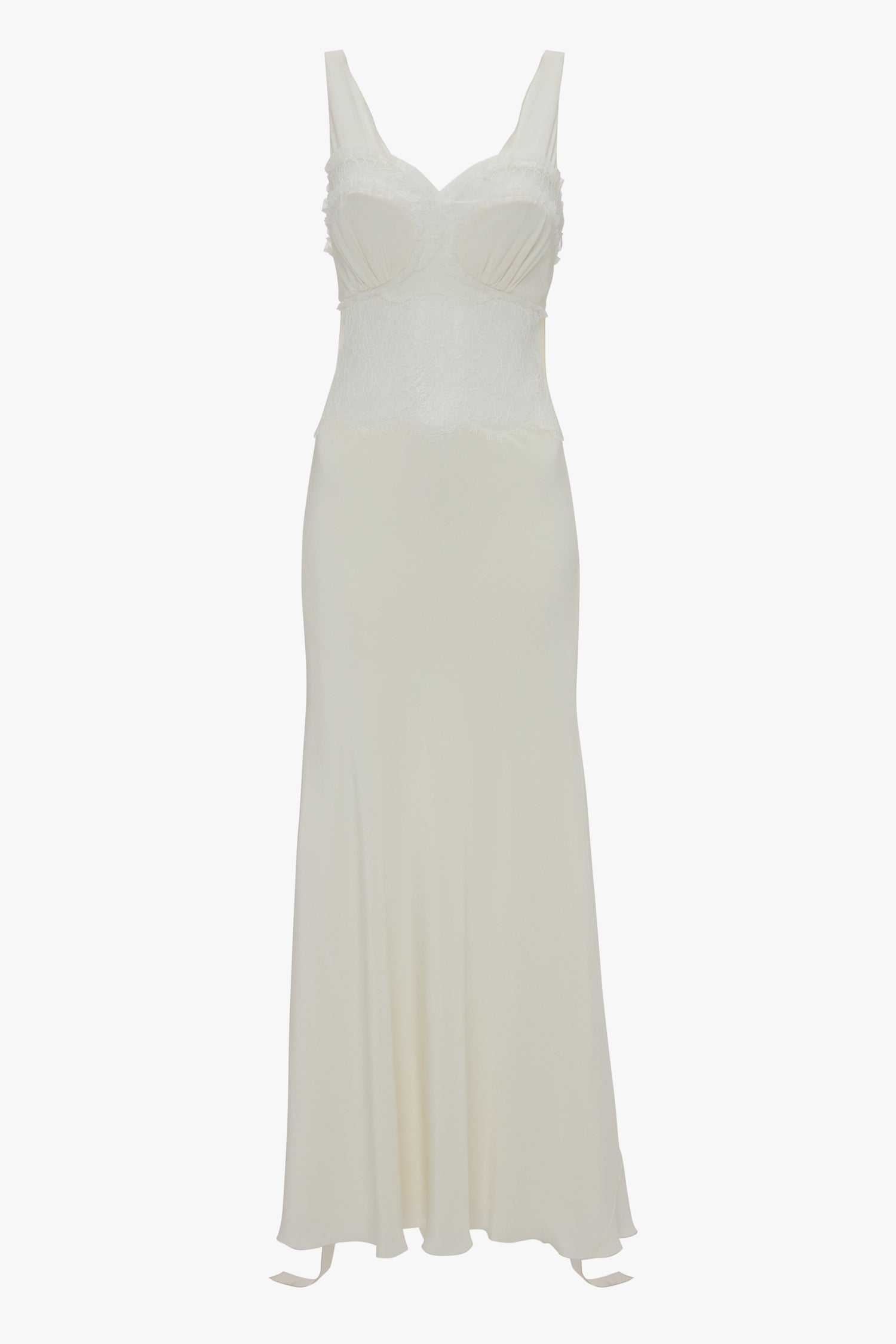 A long, off-white sleeveless dress with thin shoulder straps, a fitted bodice, and a flowing skirt. The Ruffle Detail Midi Dress In Ivory by Victoria Beckham features tactile lace detail on the bodice and a slight sheen to the fabric, epitomizing the charm found in elegant midi dresses.