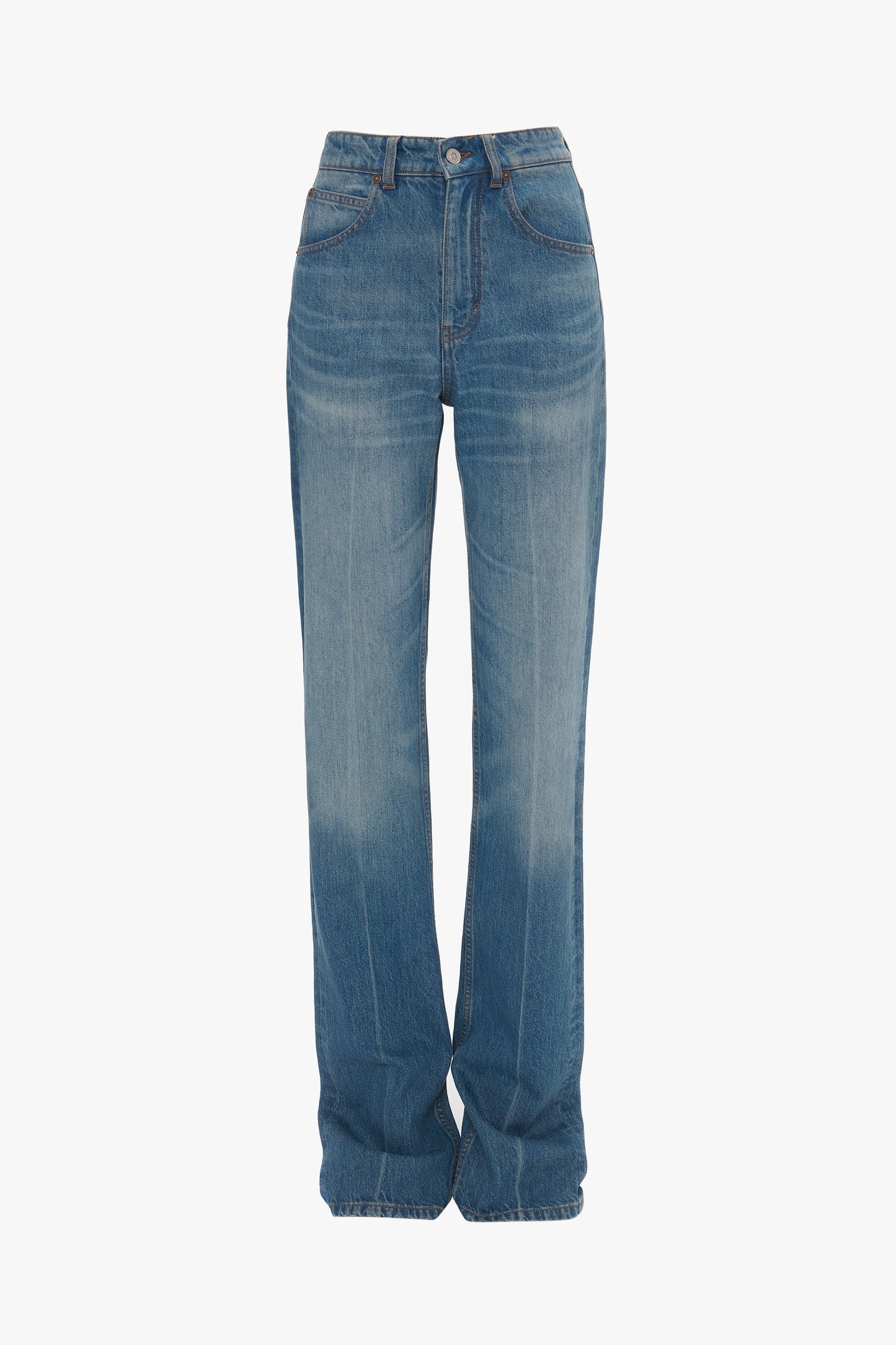 A pair of Julia Jean In Broken Vintage Wash from Victoria Beckham, blue, high-waisted, wide-leg jeans made from 100% cotton denim with slight fading on the thighs and a single button and zipper closure.