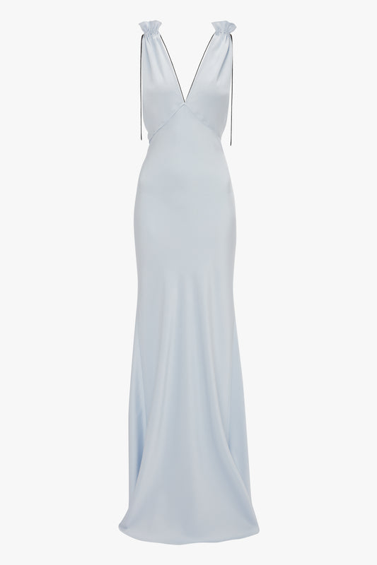 The Exclusive Gathered Shoulder Cami Floor-Length Gown In Ice Blue by Victoria Beckham features a sleek, fitted bodice made of luxurious crepe back satin and thin black straps with a V-neckline, gently flowing from the waist down.