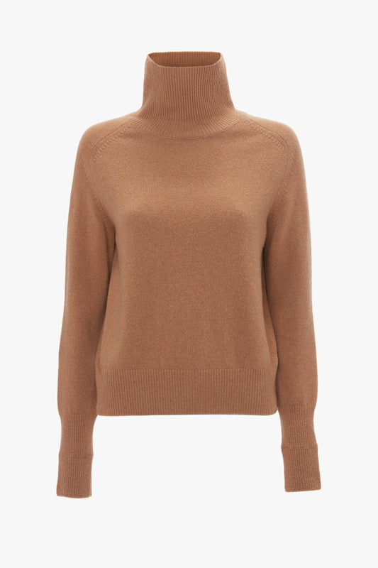 A luxury Polo Neck Jumper In Tobacco by Victoria Beckham isolated on a white background.
