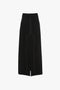 A Deconstructed Floor-Length Skirt In Black by Victoria Beckham with contrasting white stitching, featuring a high waist and front slit for an elongating silhouette.